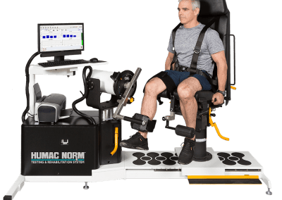 Patient sitting on HUMAC NORM isokinetic extremity system