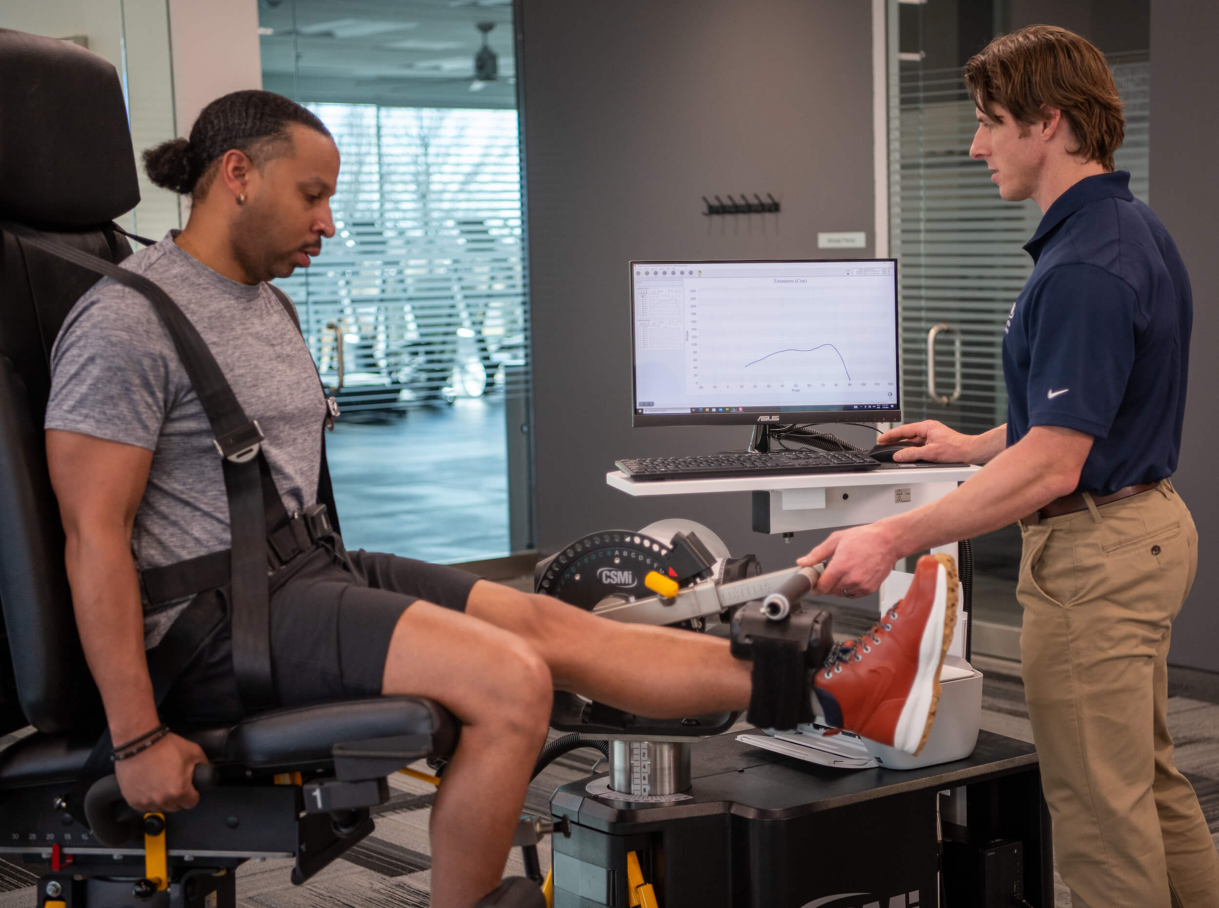 patient performing isokinetic test on humac norm extremity machine