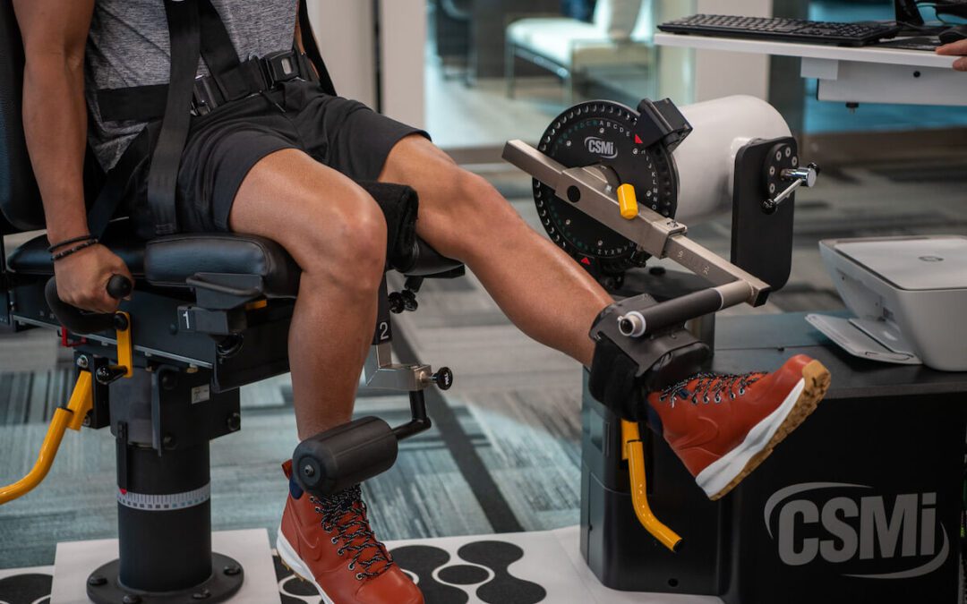 athlete performing isokinetic exercise on machine